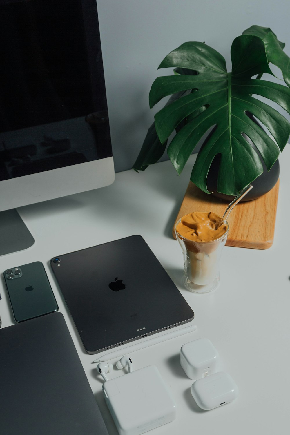 silver ipad beside silver iphone 6 on white table