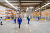 workers walking through warehouse aisle