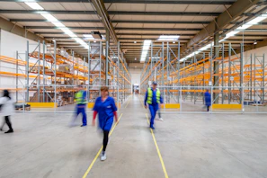 workers walking through warehouse aisle