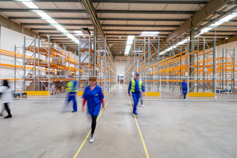 workers walking through warehouse aisle