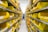 A person in a blue uniform stands in a warehouse aisle, surrounded by shelves filled with yellow plastic bins. The bins are organized and labeled, containing various items, while the industrial lighting provides a bright environment.