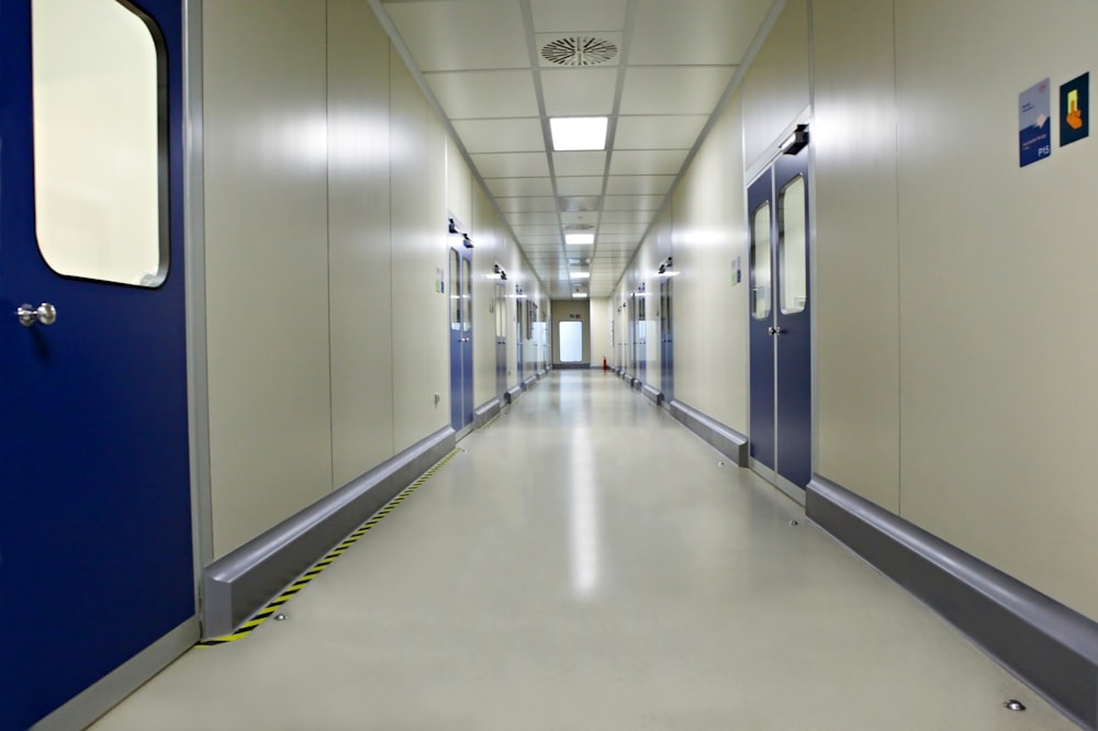 white hallway with blue doors
