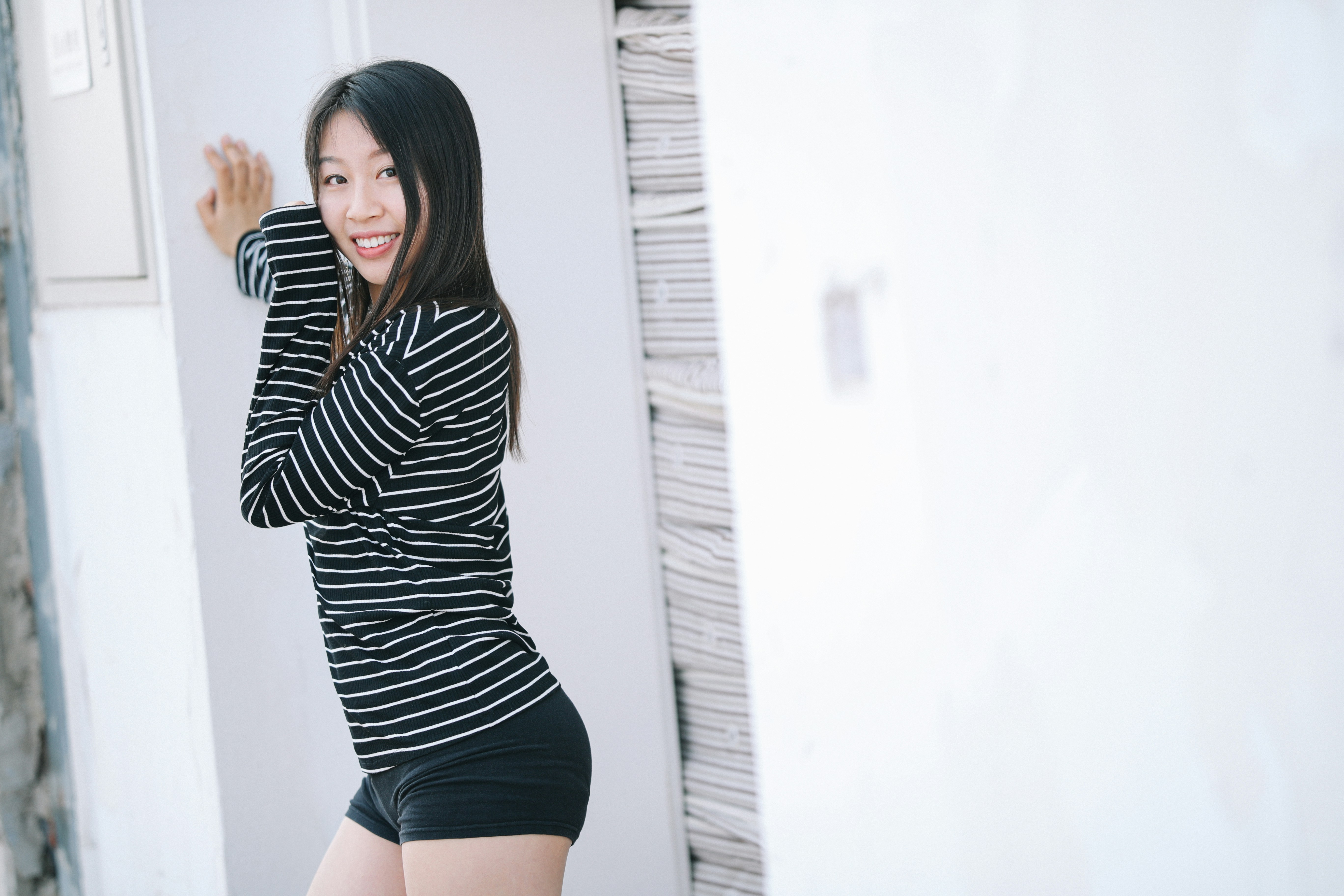 woman in black and white striped long sleeve shirt and black shorts