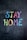 The phrase 'Stay Home' is written in colorful chalk on a dark chalkboard background. Each letter is a different color, including blue, yellow, pink, orange, green, and purple.