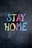The phrase 'Stay Home' is written in colorful chalk on a dark chalkboard background. Each letter is a different color, including blue, yellow, pink, orange, green, and purple.