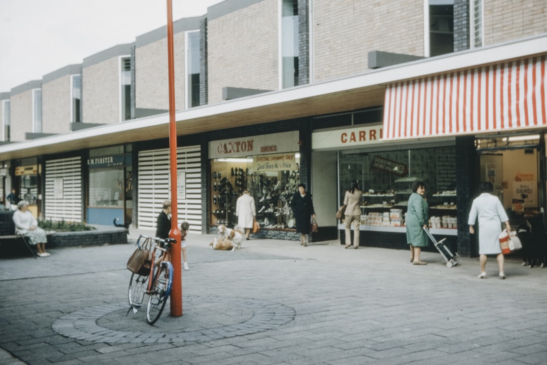 people sitting on bench near store during daytime