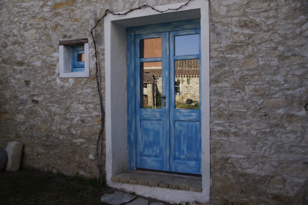 blue wooden door with glass panel