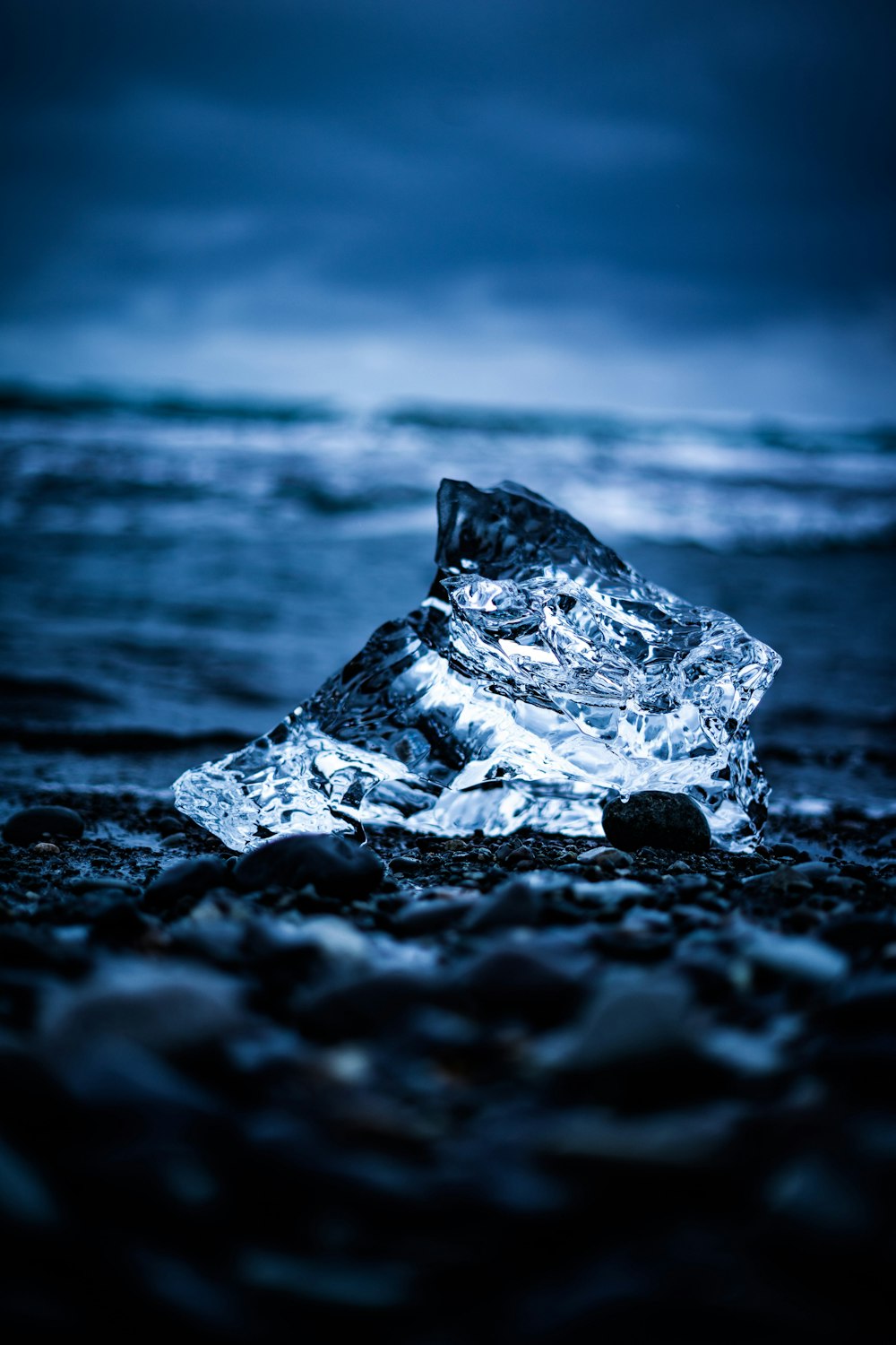 gray rock on black sand