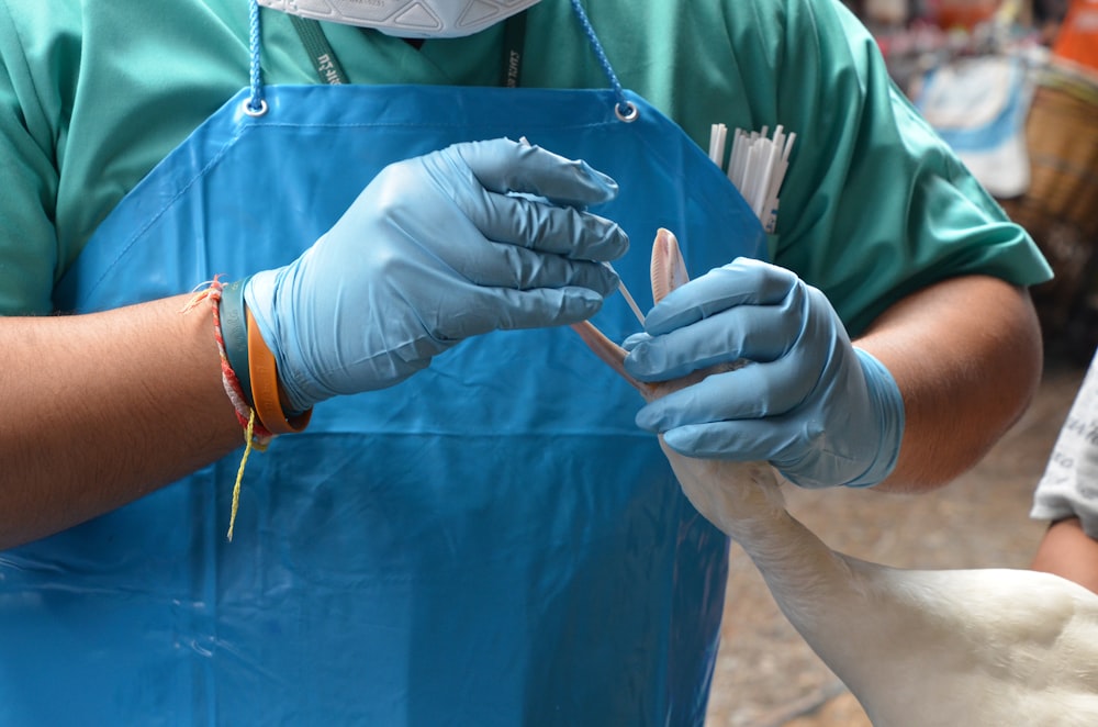 person in blue jacket holding blue textile