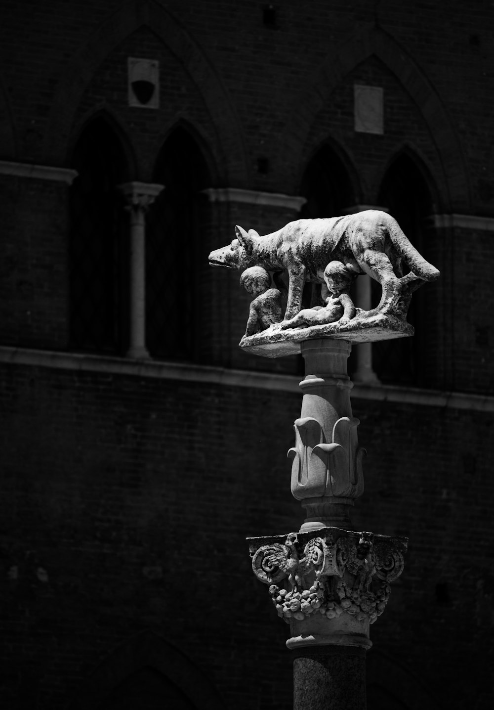 gold horse statue in front of brown brick building