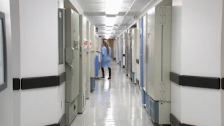 man in blue dress shirt walking on hallway