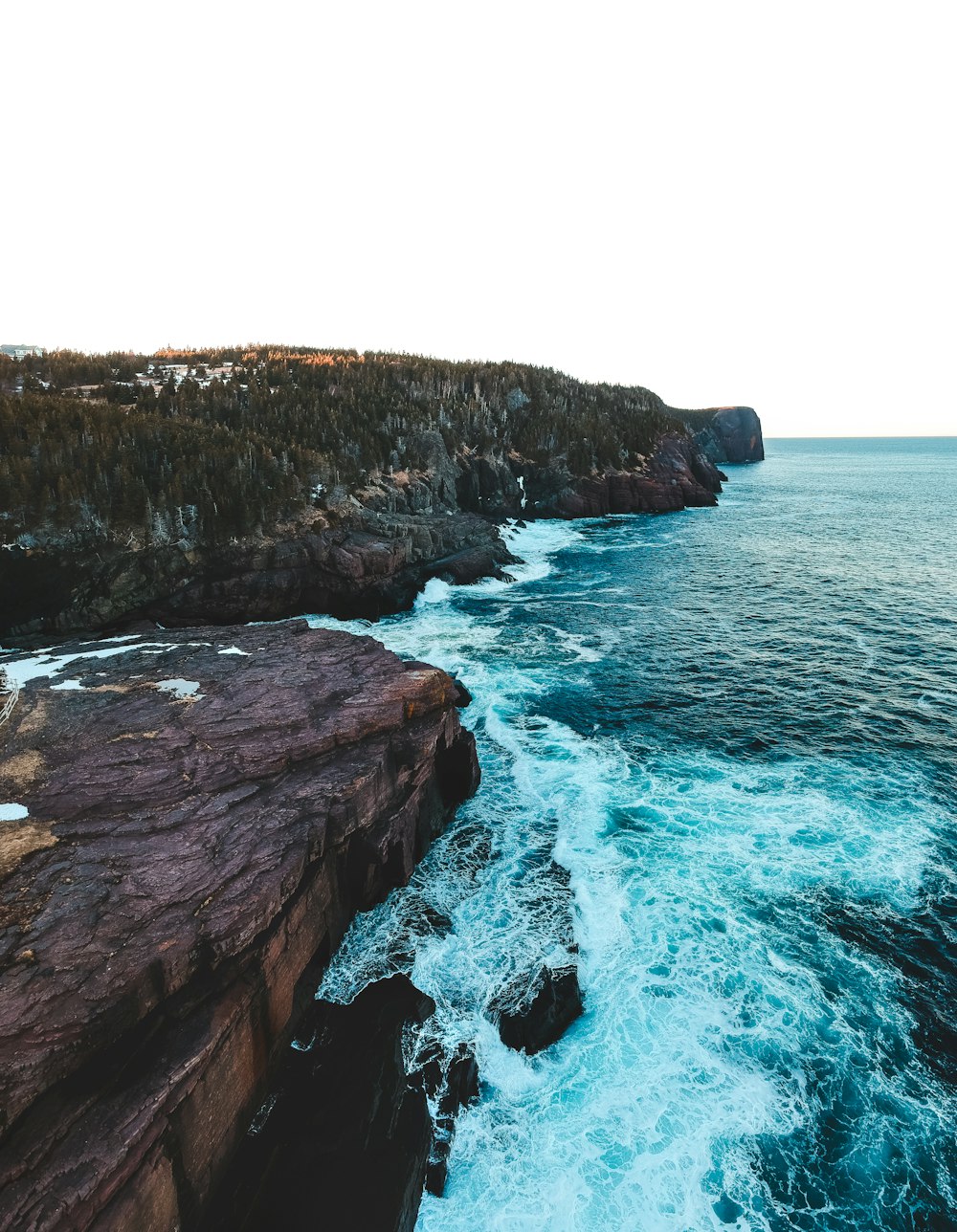 brown rock formation beside blue sea during daytime