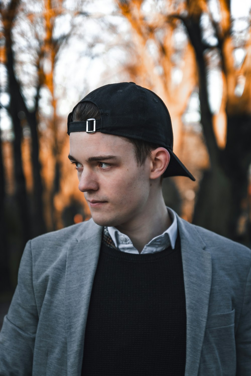 man in black hat and gray suit jacket