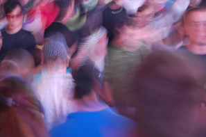 A blurred shot of a crowded border crossing, evoking tension and uncertainty.