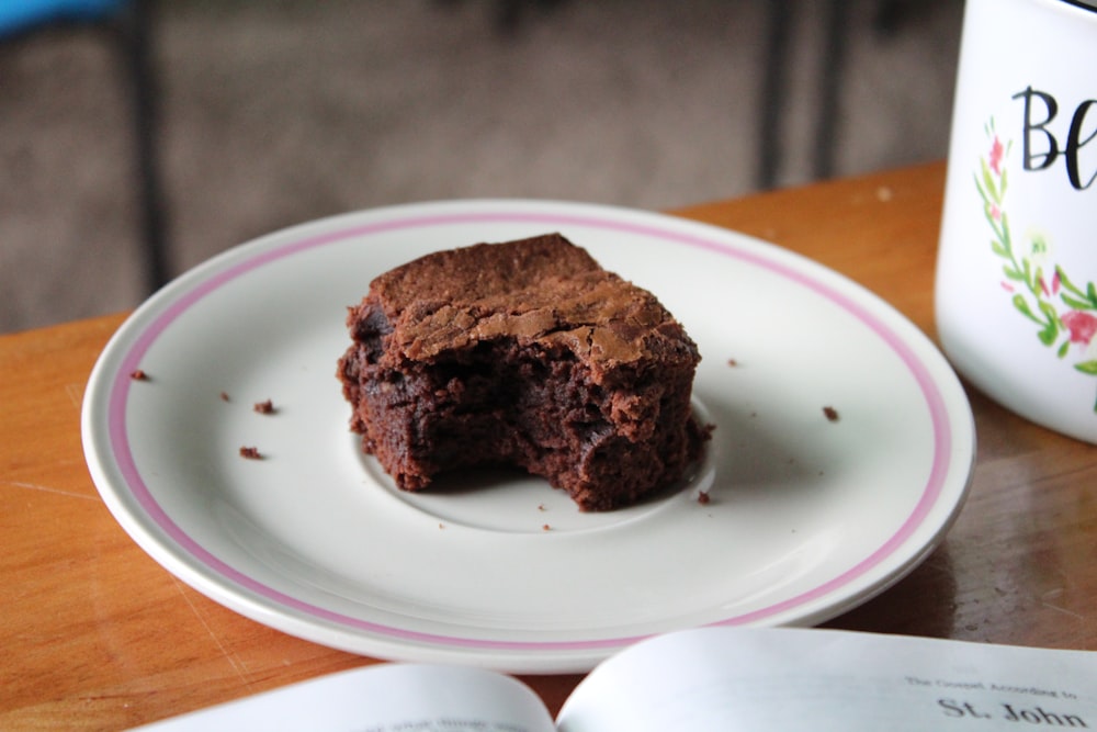 chocolate cake on white and pink ceramic plate