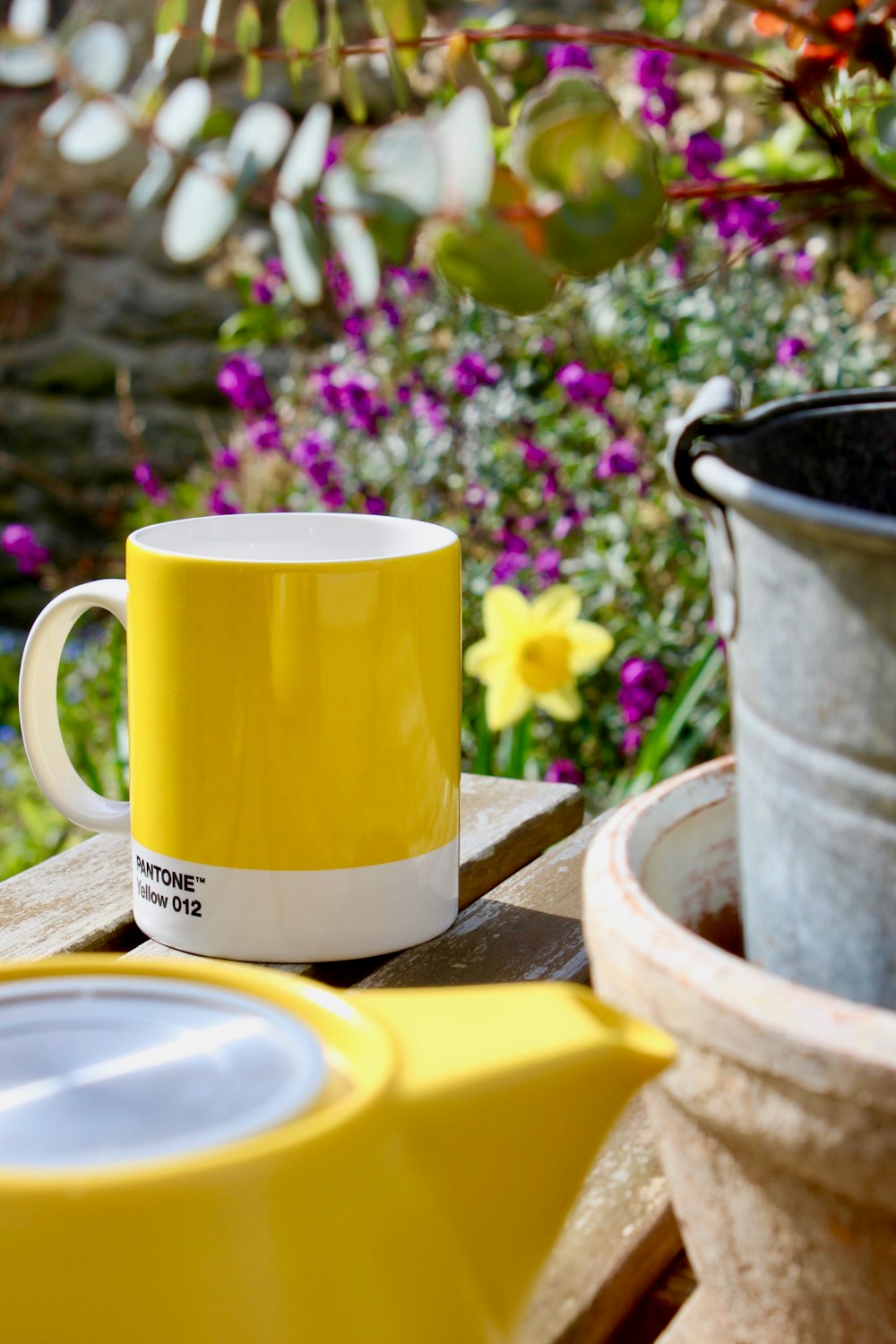 yellow ceramic mug on brown wooden table
