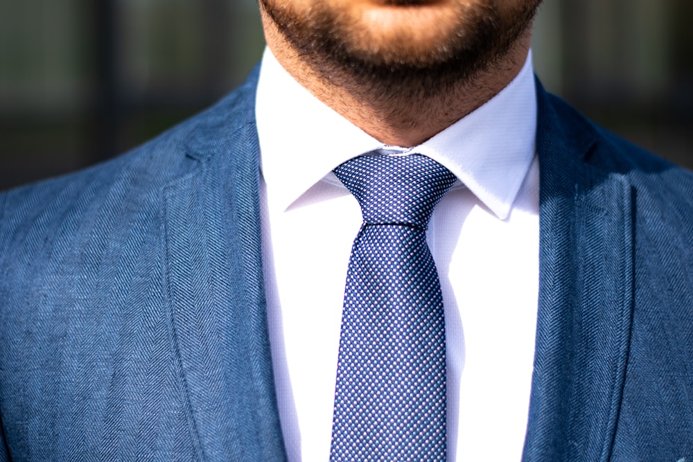man in blue suit jacket and blue necktie