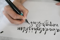 person writing on white paper