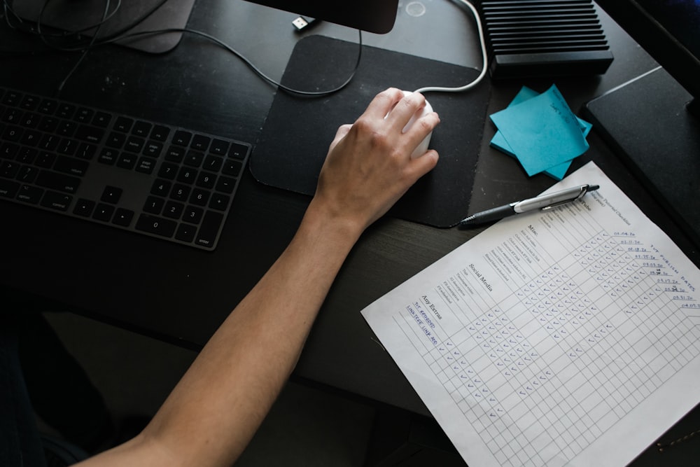 person holding black computer mouse