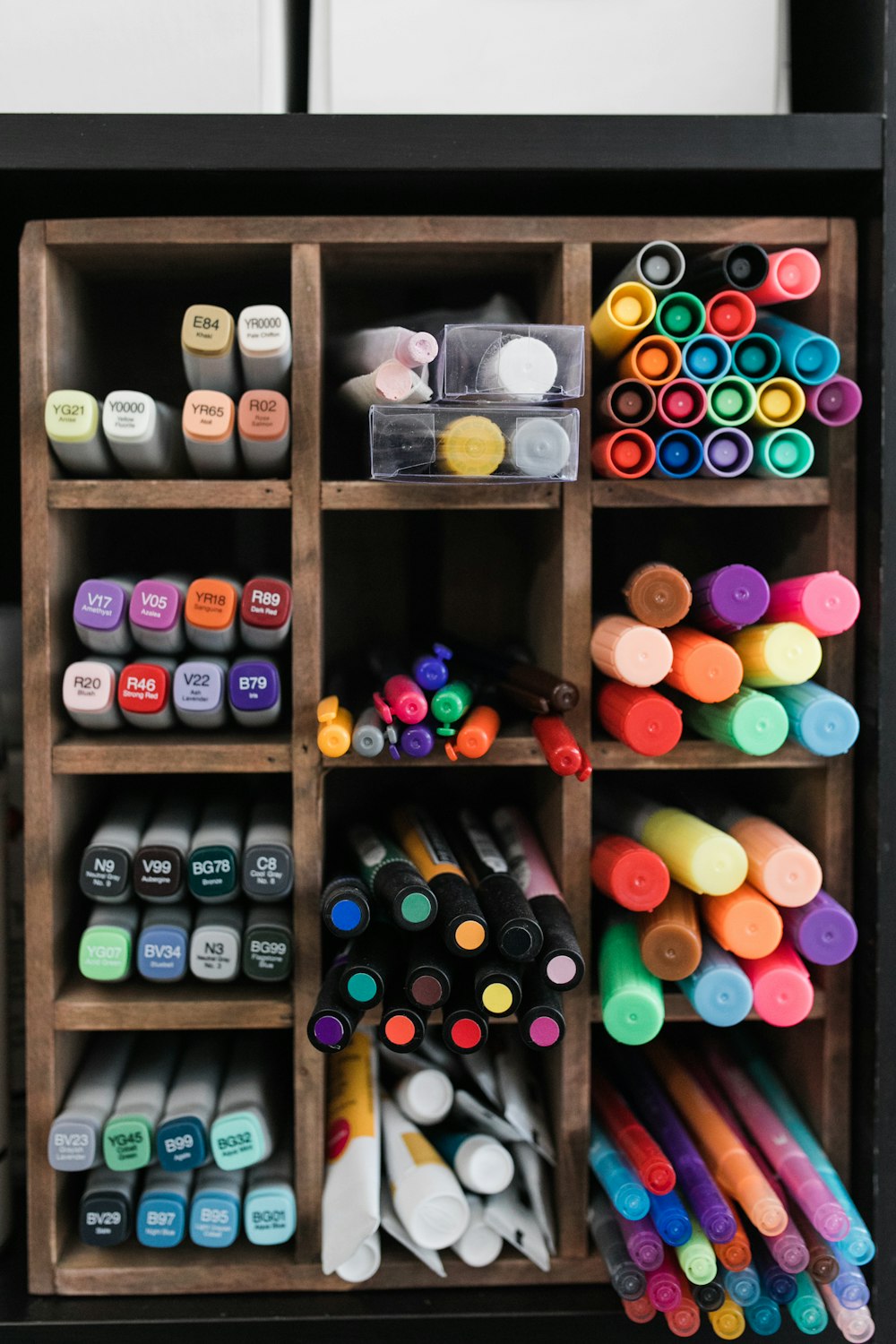 assorted color plastic bottle on brown wooden shelf