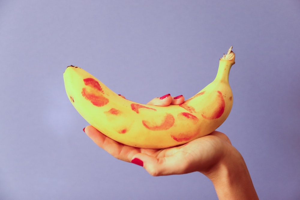 person holding yellow banana fruit