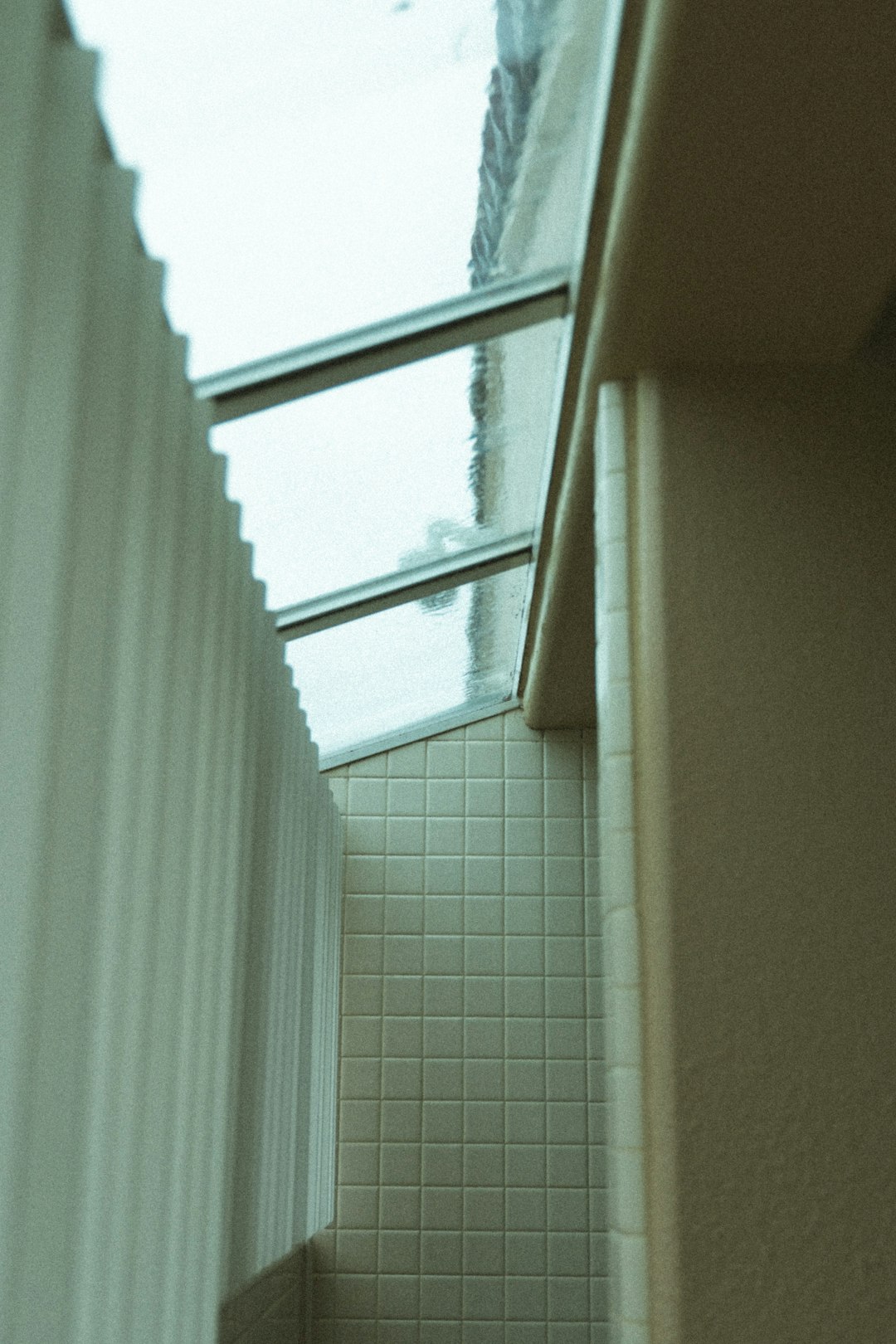 white shower curtain on white ceramic tiled wall