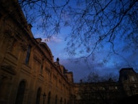 An elegant building exterior at dusk, highlighting architectural details and ambient lighting.