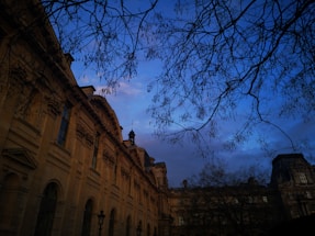 Elegant evening view of Baddiley Hall's grand facade softly lit against a twilight sky.