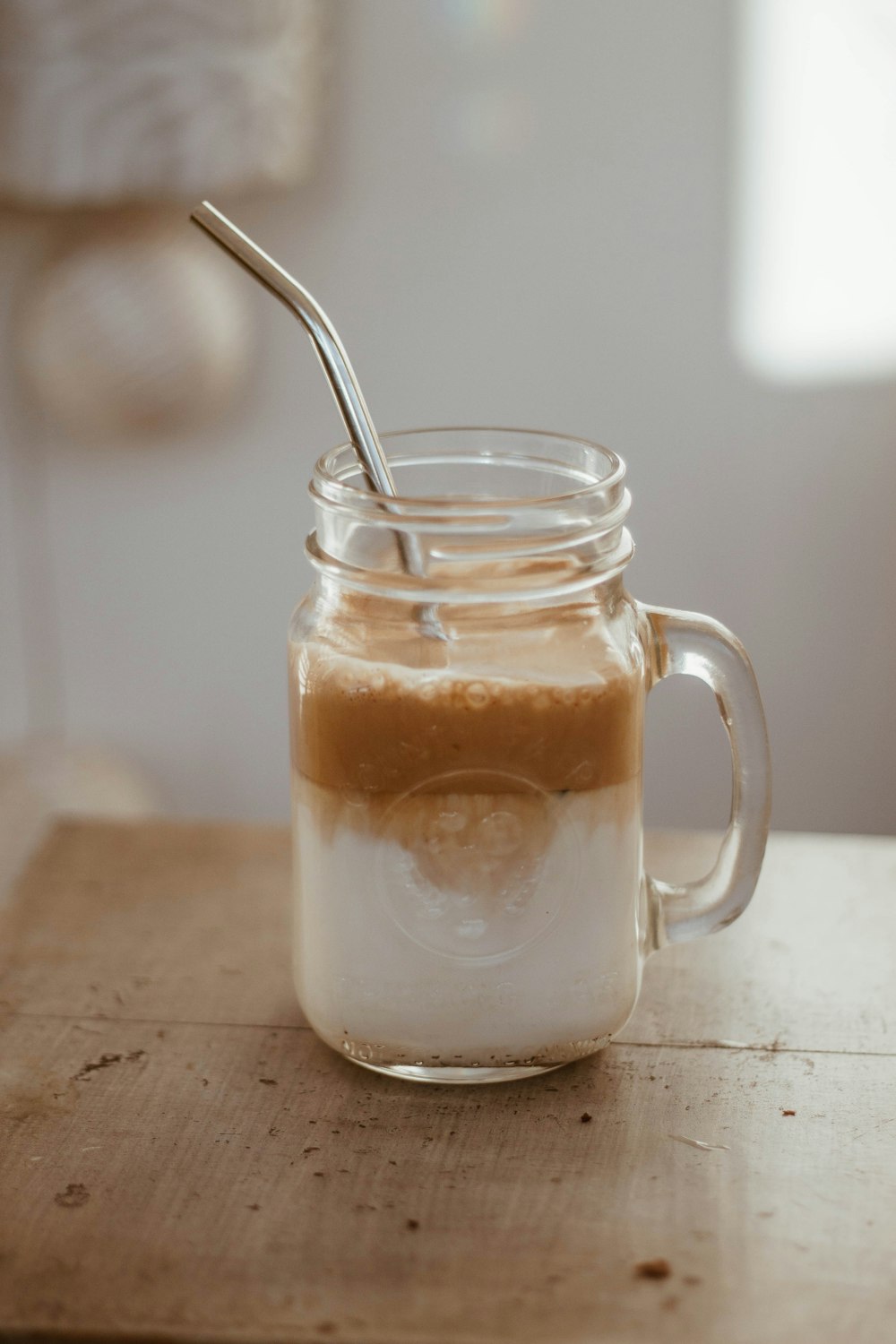 clear glass mug with brown liquid