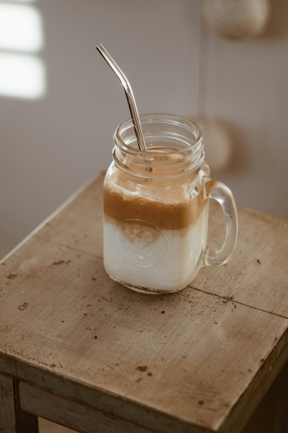 clear glass mug with brown liquid