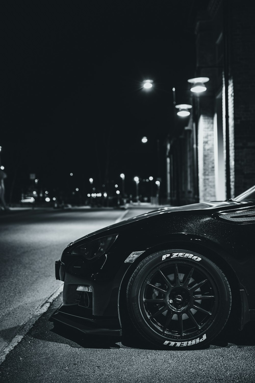 black car on road in grayscale photography