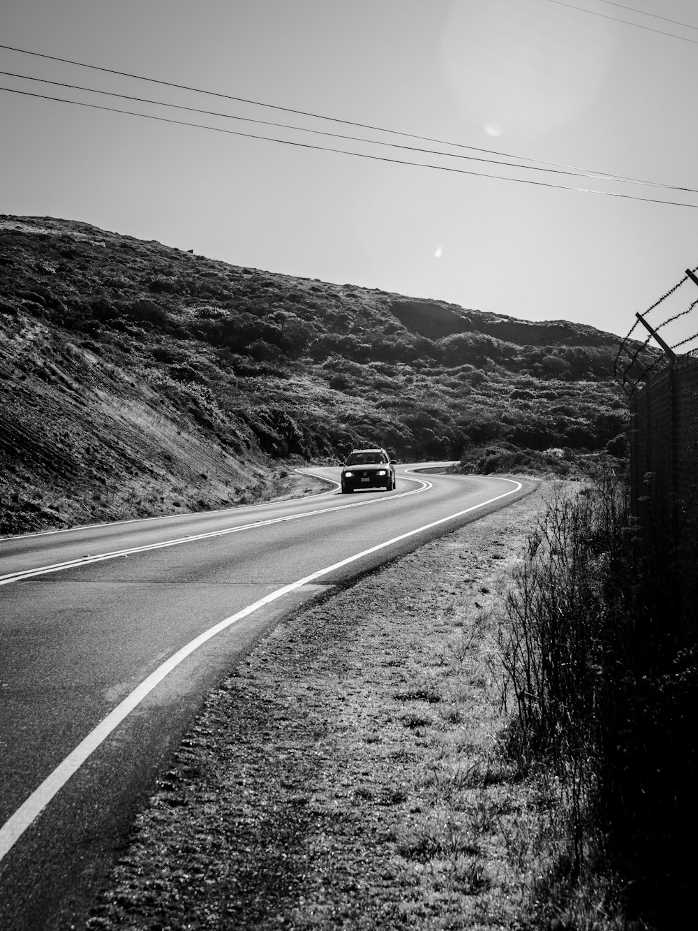 grayscale photo of car on road