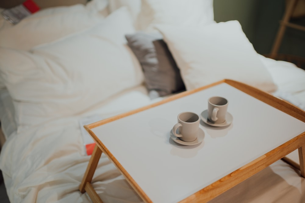 white ceramic teacup on white ceramic saucer on brown wooden table