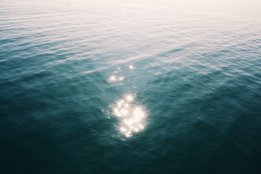 white boat on blue sea during daytime