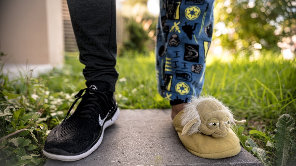 brown bear plush toy on black and blue shoes