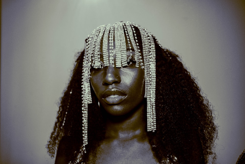 woman with curly hair wearing silver necklace