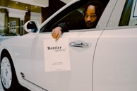 A car registration document being signed at the notary’s desk.