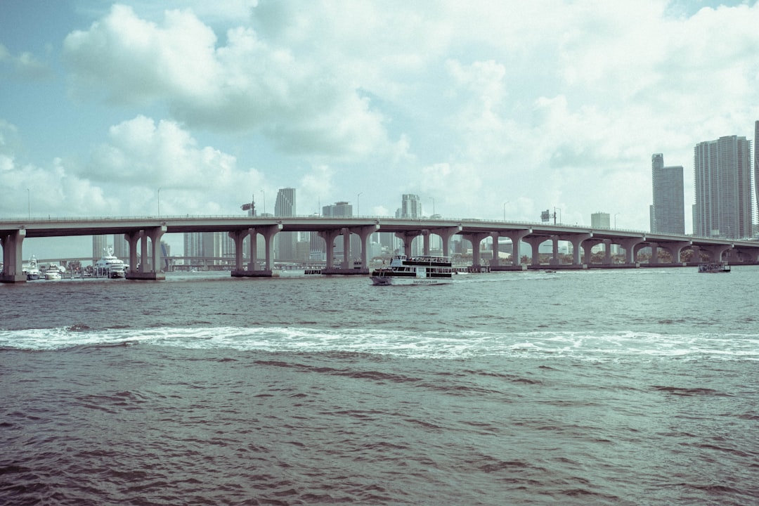 white concrete bridge over the sea during daytime