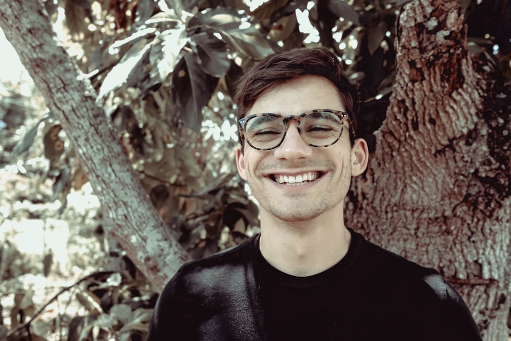 man in black crew neck shirt wearing black framed eyeglasses