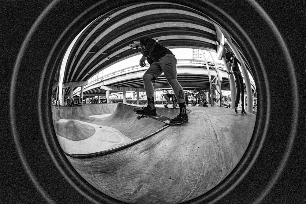 man in black t-shirt and black pants doing skateboard stunts