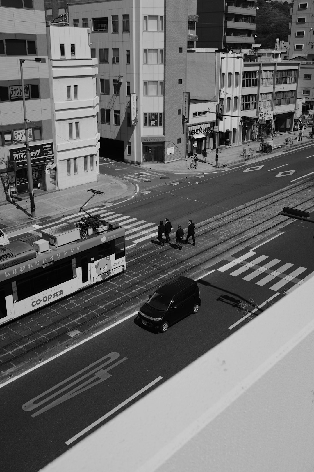 grayscale photo of people walking on pedestrian lane