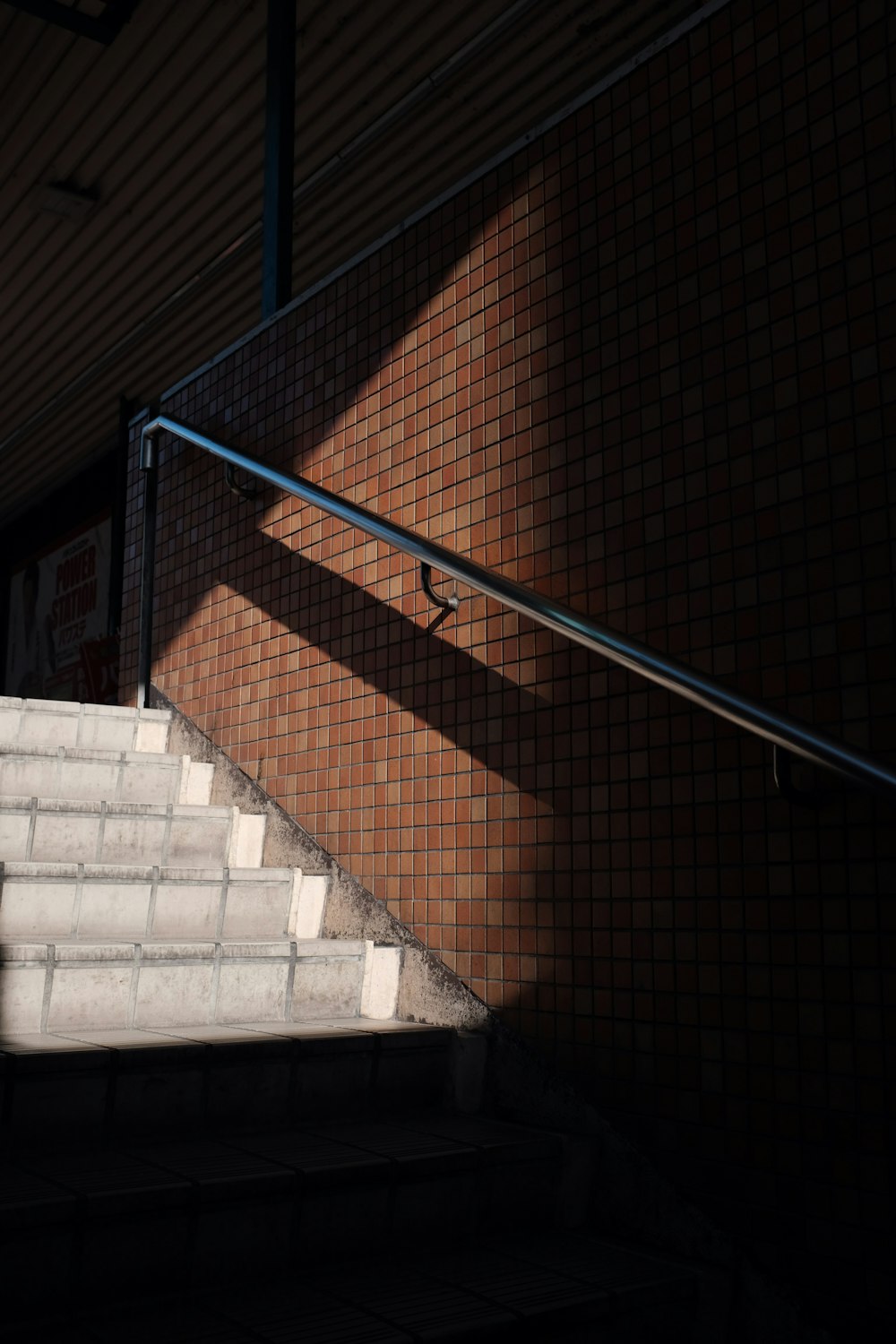 blue metal railings on brown concrete staircase