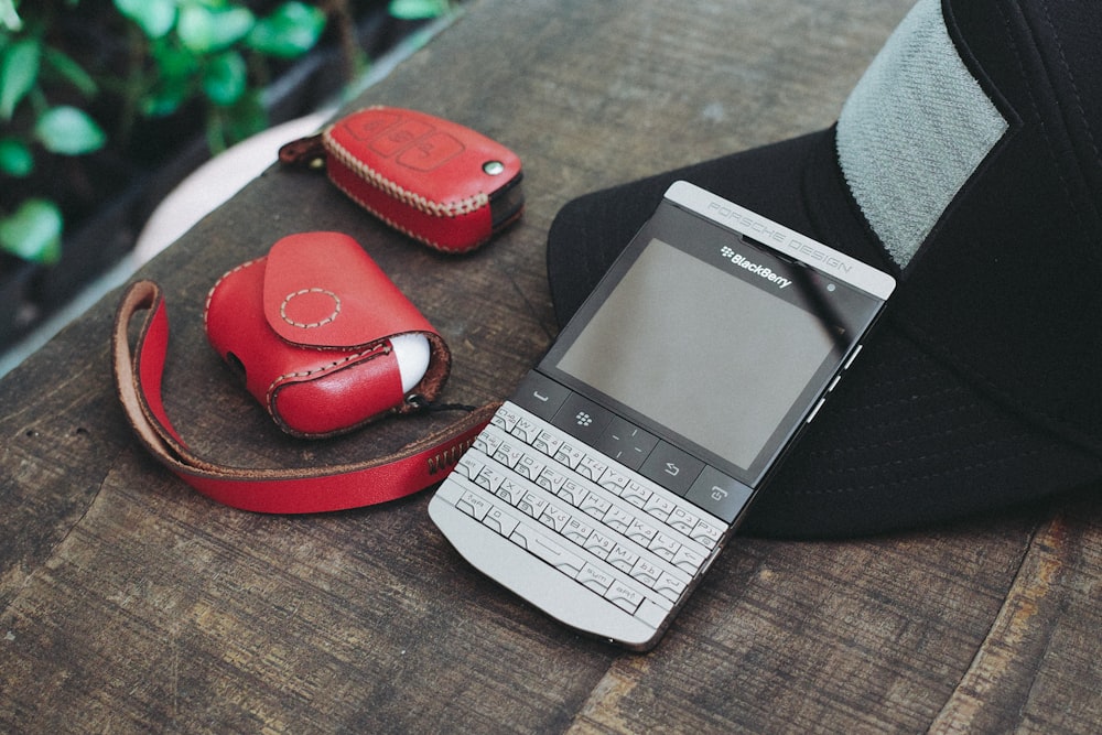silver and black qwerty phone on red flip flop