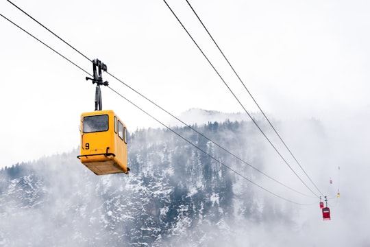 yellow cable car over snow covered ground in Sankt Gilgen Austria