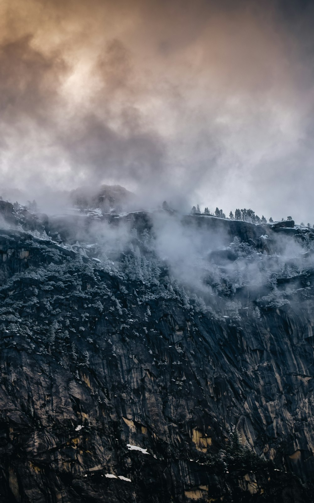 gray and brown mountain under white clouds during daytime