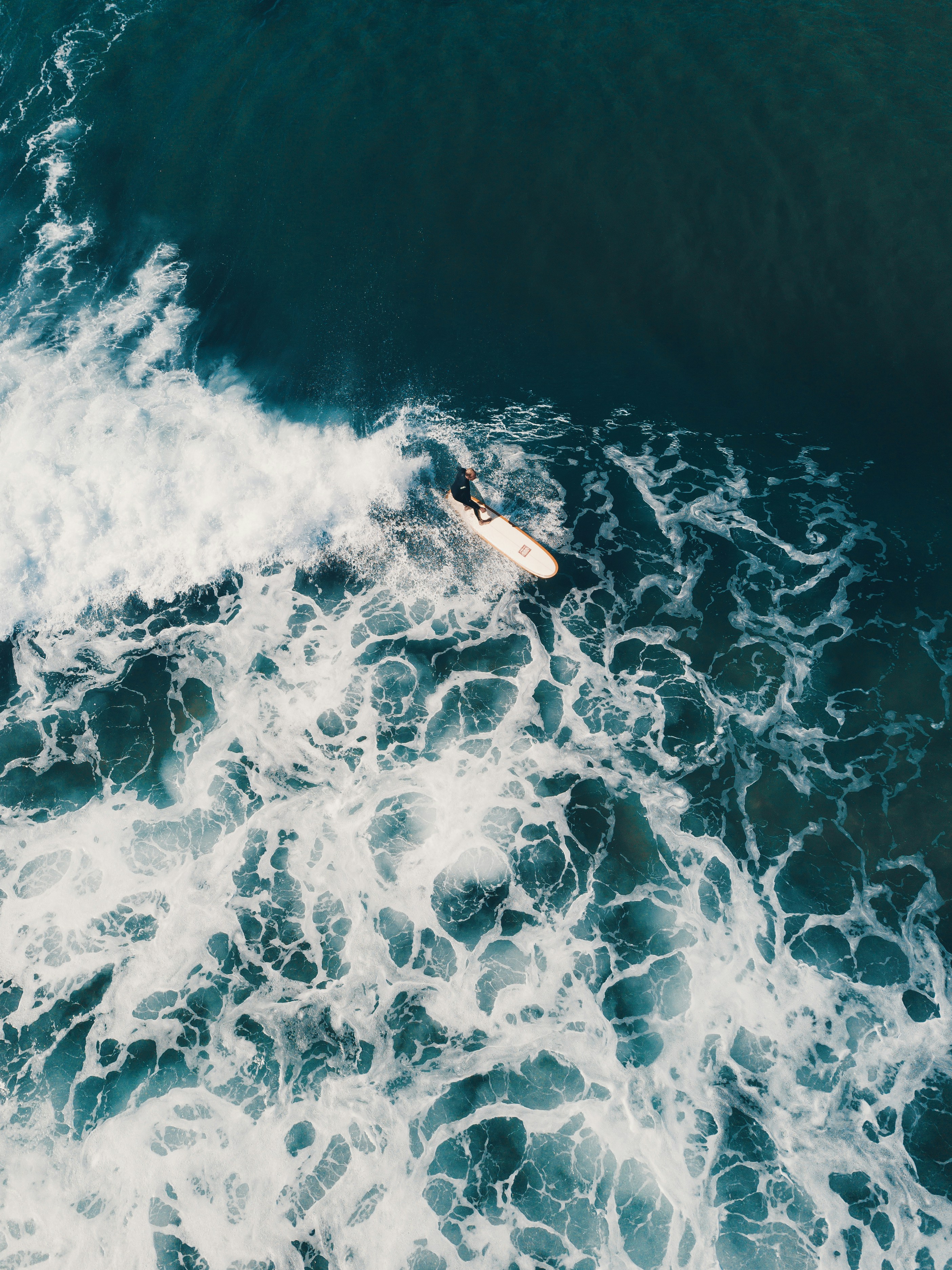 person surfing on sea waves during daytime