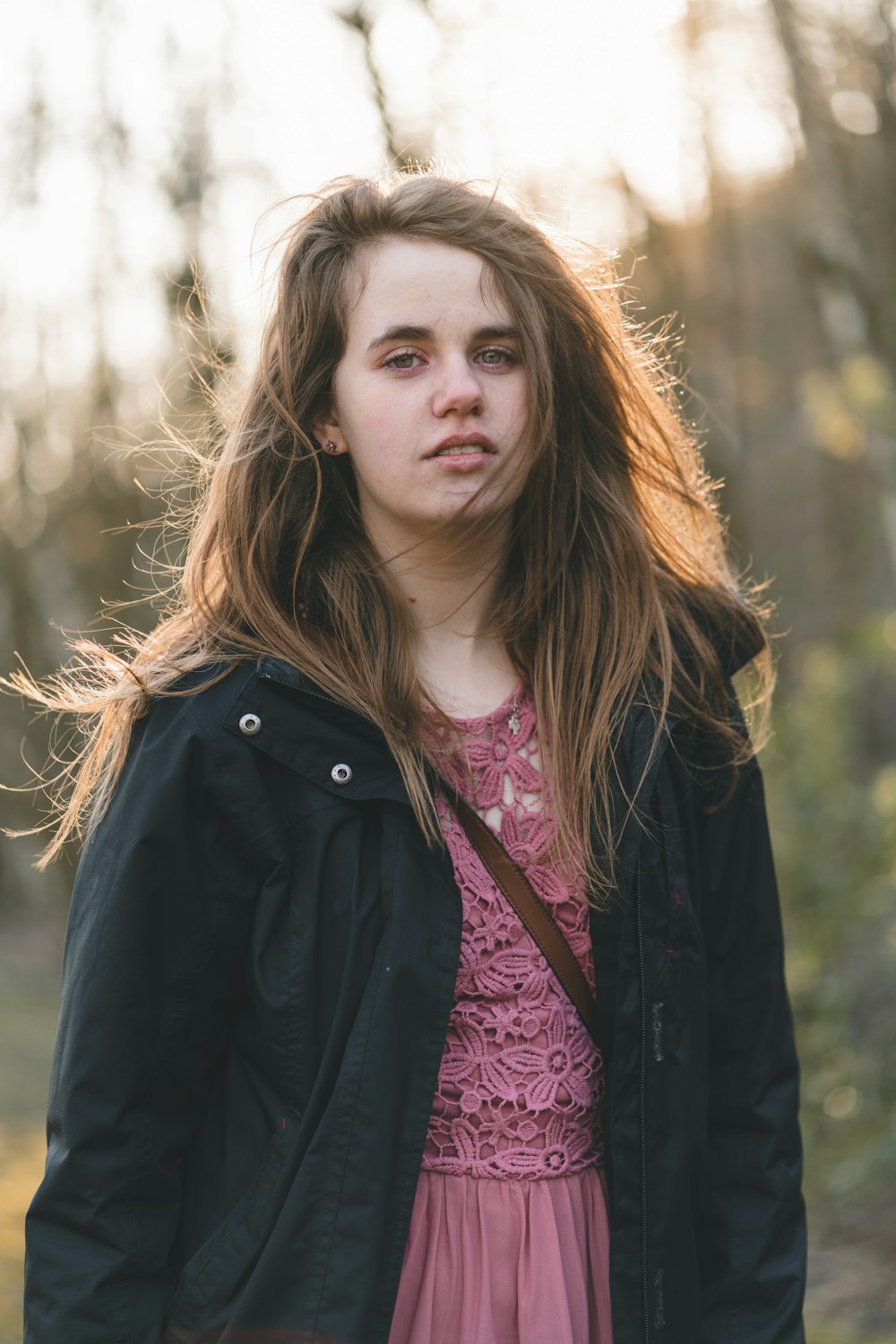 woman in black jacket standing during daytime