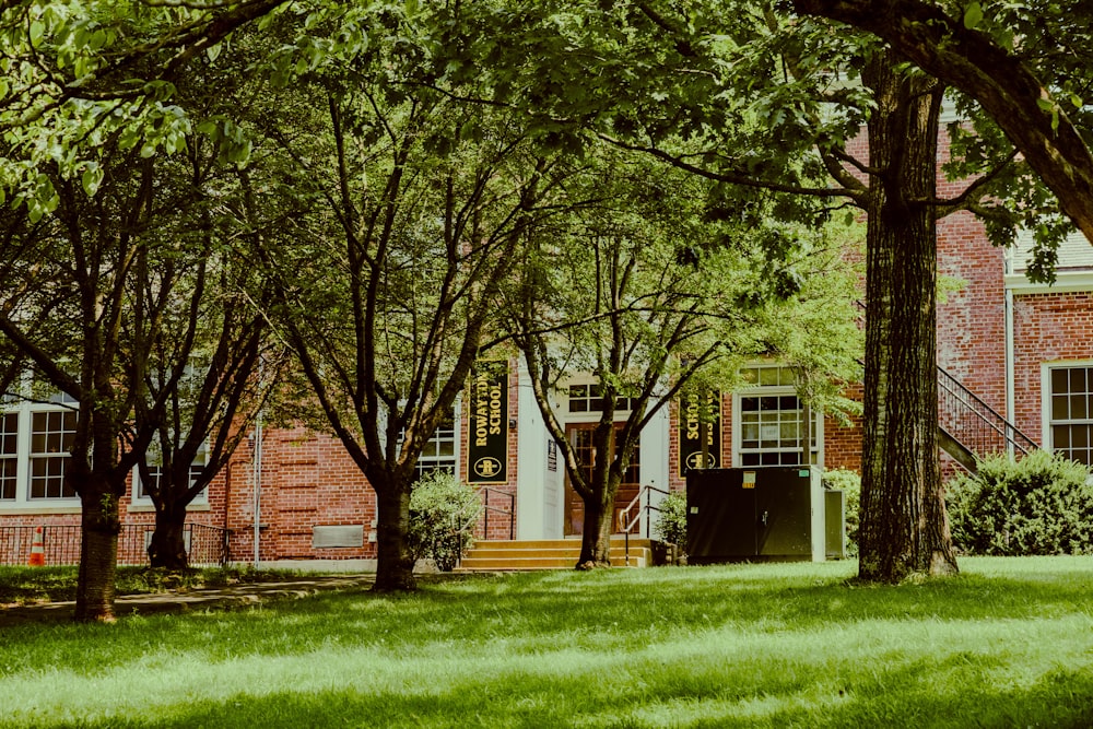 brown and white house near green trees during daytime