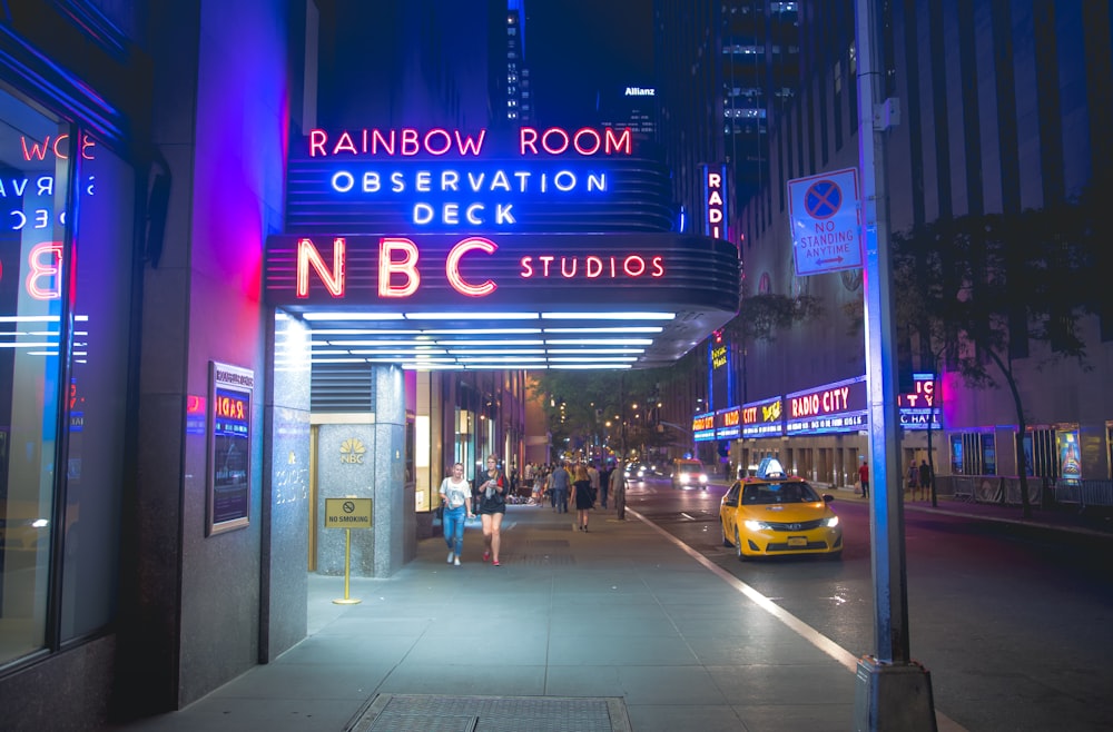 yellow taxi cab on street during night time