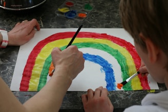 person painting a multi color paint